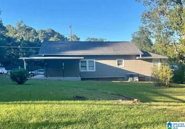 back of house featuring a lawn and a patio area