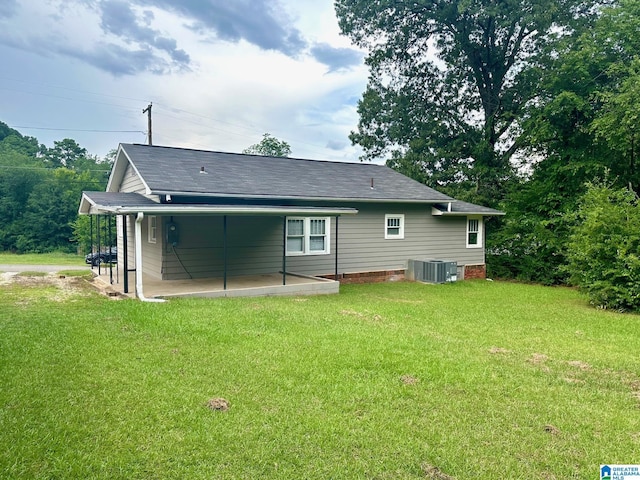 back of house with a lawn, a patio, and central AC