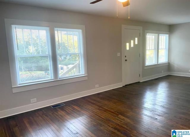 interior space with ceiling fan and dark hardwood / wood-style flooring