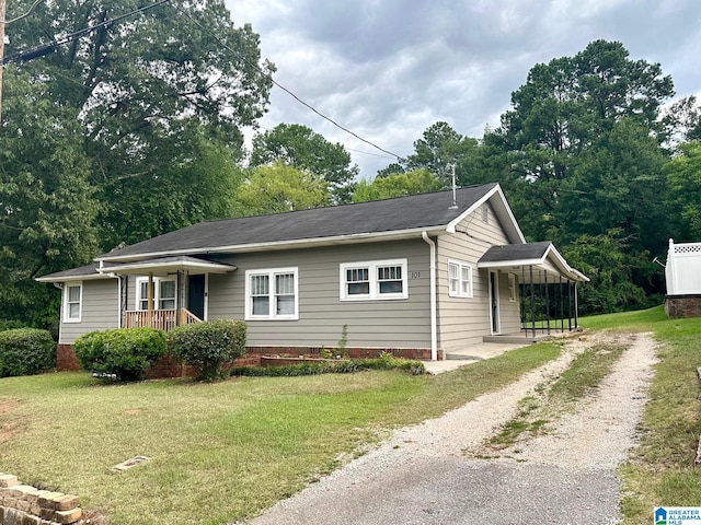 view of front of home with covered porch and a front lawn