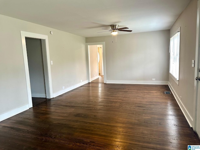 spare room with ceiling fan and dark wood-type flooring