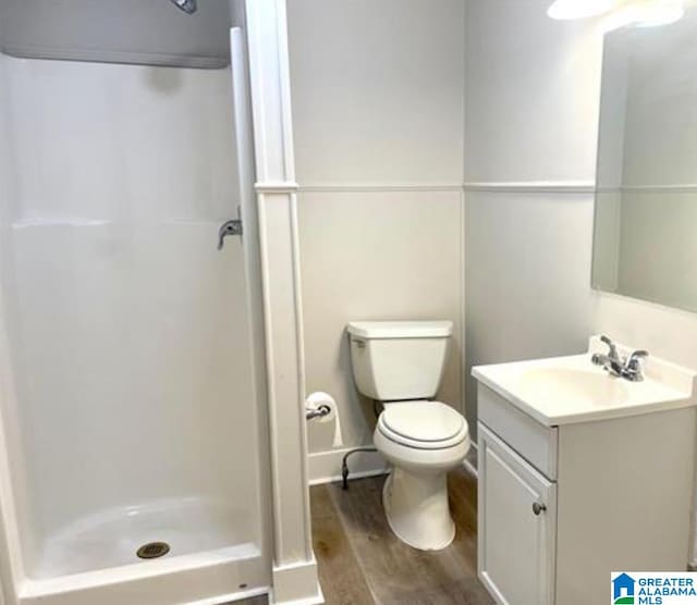 bathroom with vanity, walk in shower, wood-type flooring, and toilet