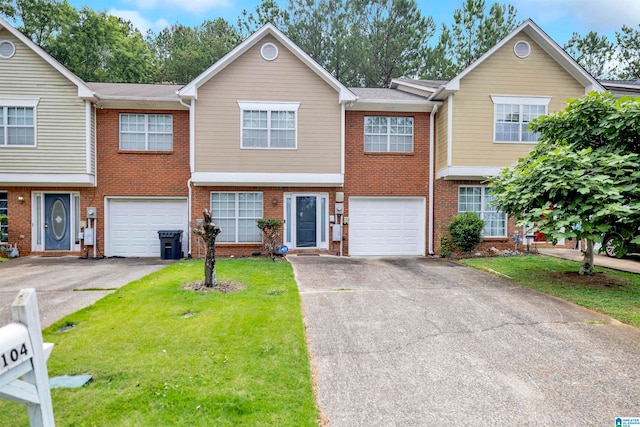 view of property featuring a garage and a front lawn