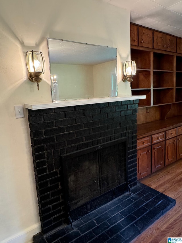 details featuring wood-type flooring and a brick fireplace