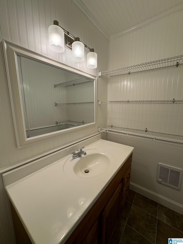 bathroom with tile patterned floors, vanity, and ornamental molding