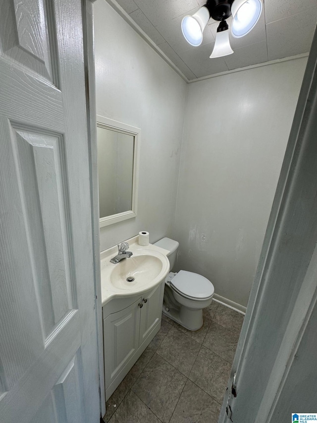 bathroom with tile patterned floors, vanity, and toilet