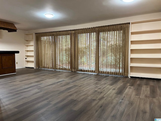 unfurnished living room with dark hardwood / wood-style floors