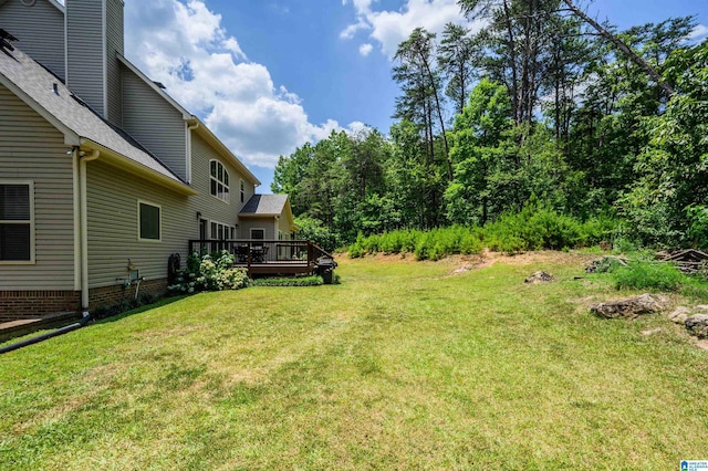 view of yard featuring a wooden deck