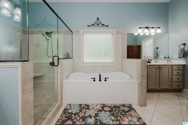 bathroom with tile patterned floors, separate shower and tub, and vanity