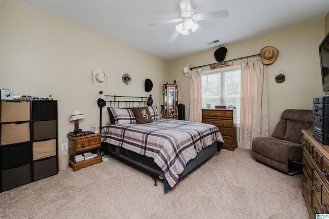 bedroom featuring light colored carpet and ceiling fan