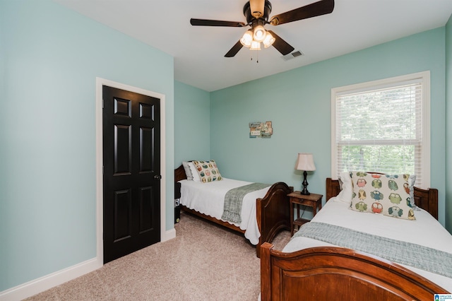 bedroom featuring light carpet and ceiling fan