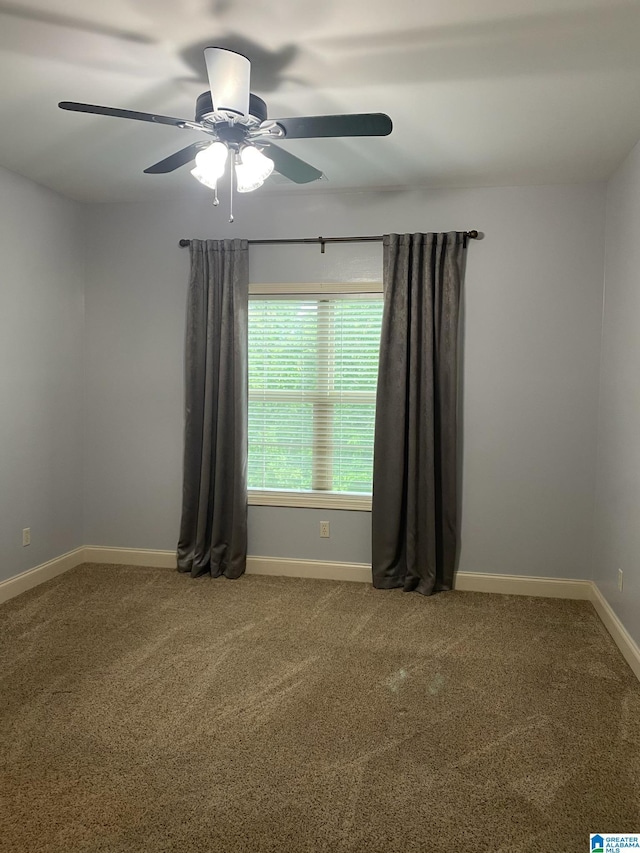 spare room with carpet floors and ceiling fan