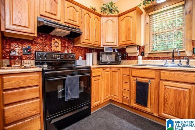 kitchen with backsplash, exhaust hood, sink, and black appliances