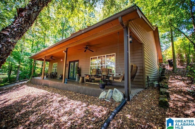 rear view of house featuring ceiling fan and a patio