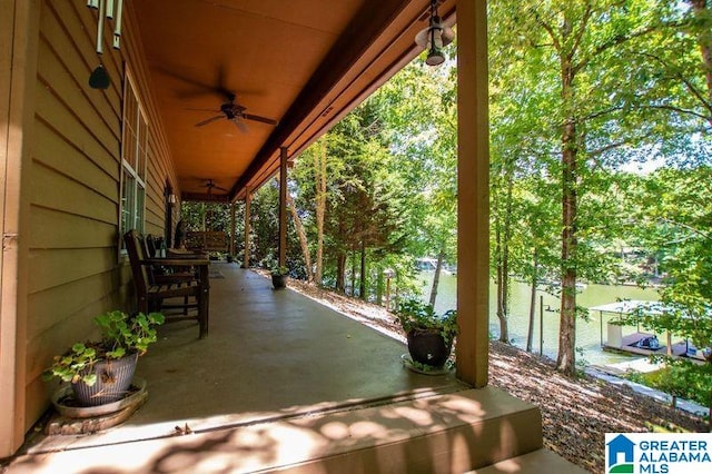 view of patio with ceiling fan and a water view