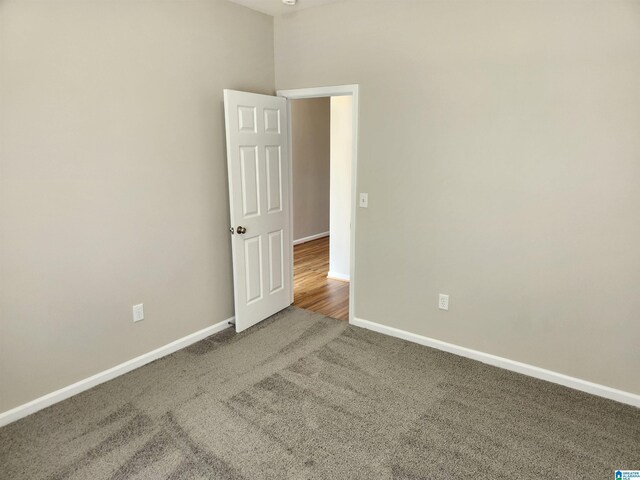 carpeted empty room with a high ceiling