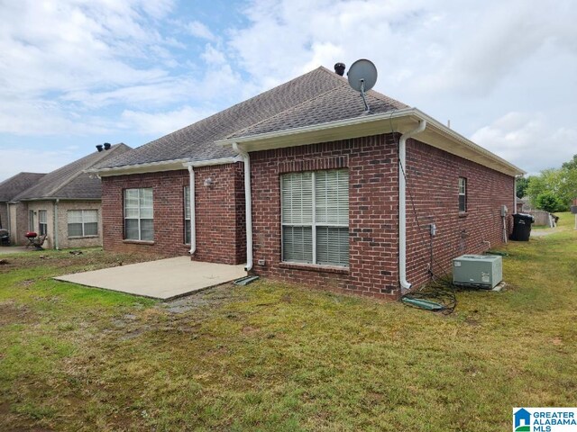 back of property with a patio and a lawn