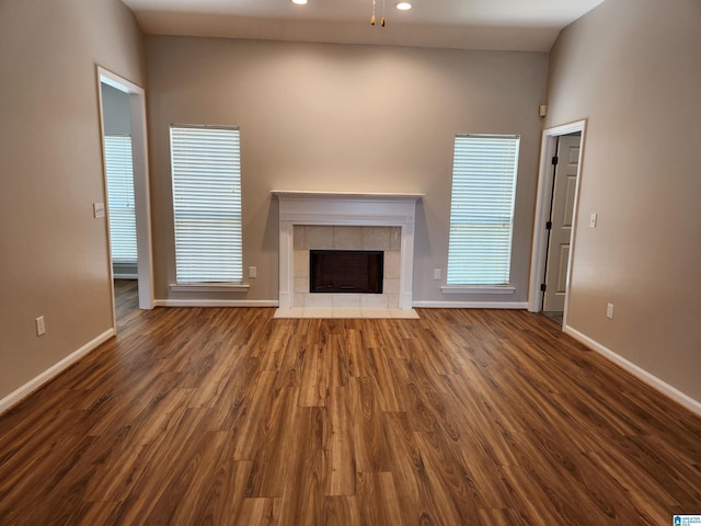 unfurnished living room with a fireplace, baseboards, dark wood-style flooring, and recessed lighting