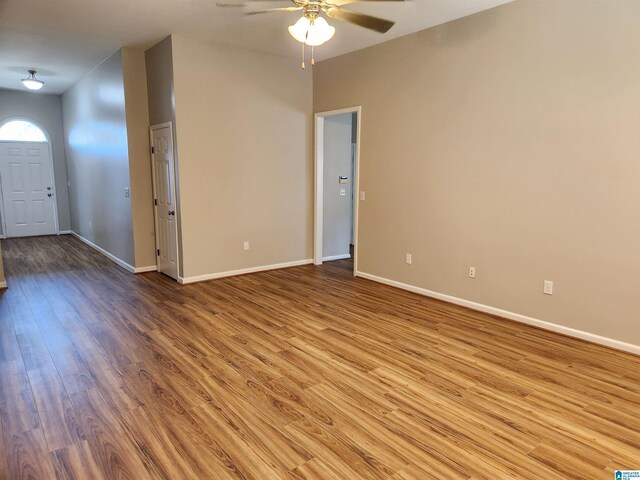 unfurnished living room featuring ceiling fan and wood-type flooring