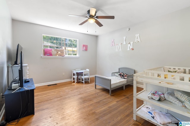 bedroom featuring hardwood / wood-style flooring and ceiling fan