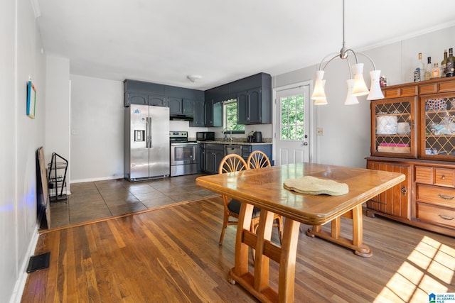 dining space with dark wood-type flooring and a chandelier