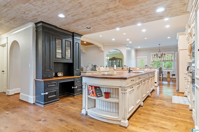 kitchen featuring hanging light fixtures, stainless steel appliances, wooden ceiling, butcher block countertops, and light hardwood / wood-style floors