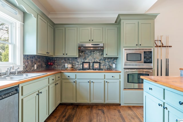 kitchen with sink, butcher block countertops, plenty of natural light, dark hardwood / wood-style flooring, and stainless steel appliances