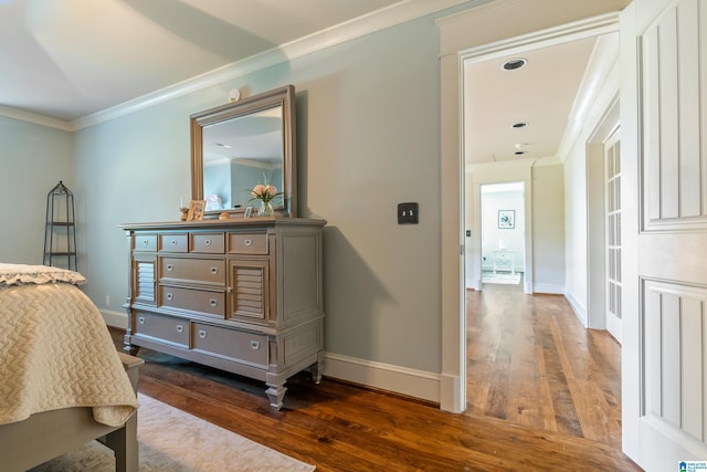 bedroom with ceiling fan, dark wood-type flooring, and ornamental molding