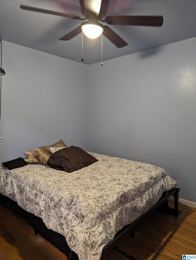 bedroom with ceiling fan and wood-type flooring