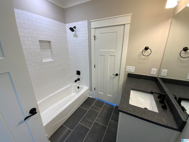 bathroom with tile flooring, vanity, and tiled shower / bath combo