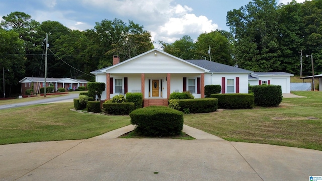 ranch-style house featuring covered porch and a front lawn