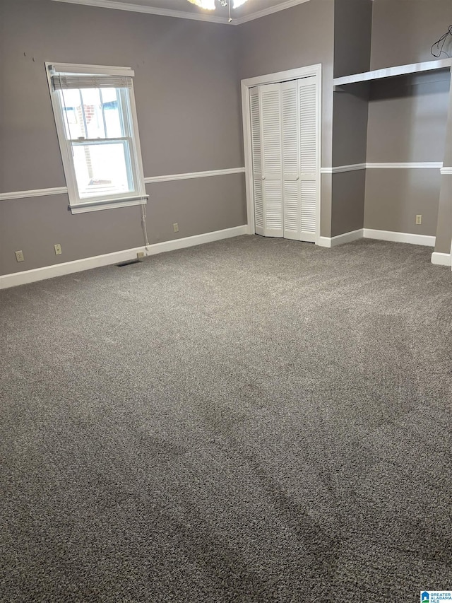 unfurnished bedroom featuring carpet flooring and a closet