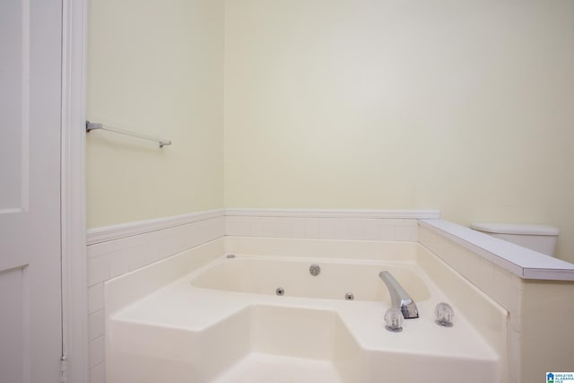 bathroom with toilet and a tub