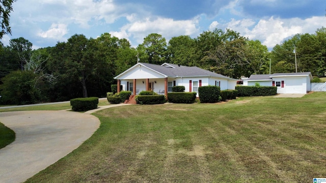 ranch-style home with covered porch, a garage, an outdoor structure, and a front yard