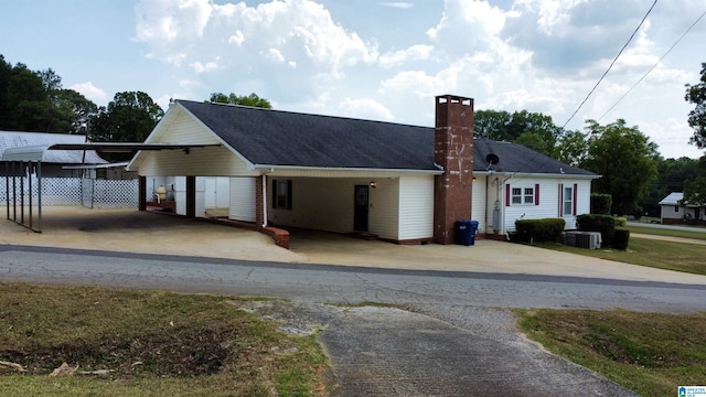 view of front of house featuring a carport and central AC