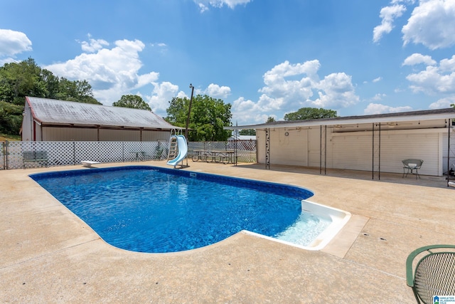 view of swimming pool featuring a patio and a water slide