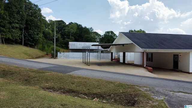 view of front of home with a front yard and a carport