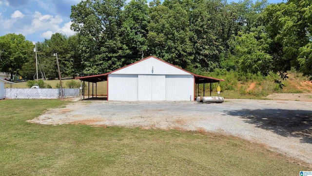 garage featuring a carport and a lawn