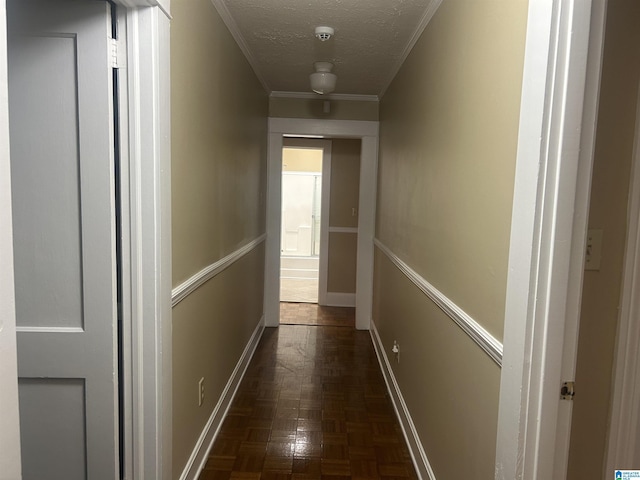 hallway featuring dark parquet flooring, crown molding, and a textured ceiling