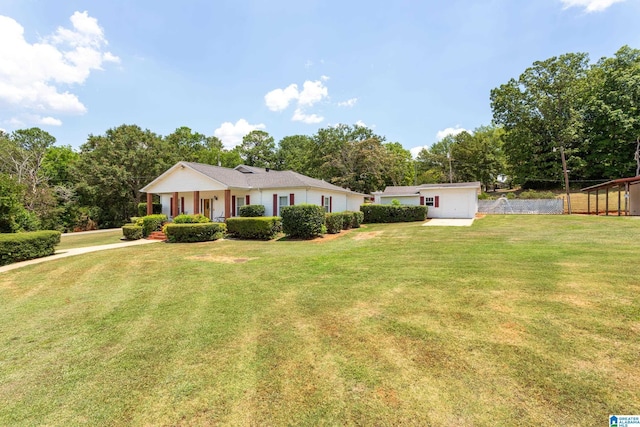 ranch-style home featuring covered porch and a front yard