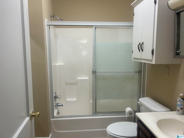 full bathroom featuring shower / bath combination with glass door, vanity, and toilet