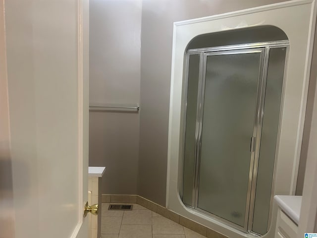 bathroom featuring tile patterned floors and an enclosed shower