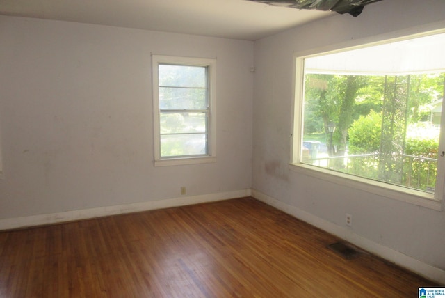 empty room with dark hardwood / wood-style flooring