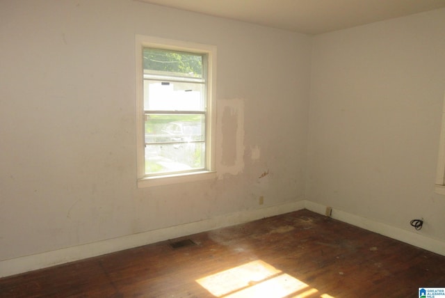 spare room featuring dark hardwood / wood-style floors