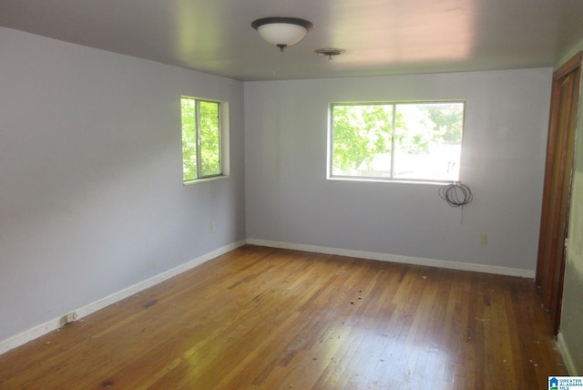 unfurnished room featuring hardwood / wood-style floors