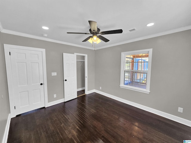 unfurnished bedroom with ceiling fan, crown molding, and dark wood-type flooring