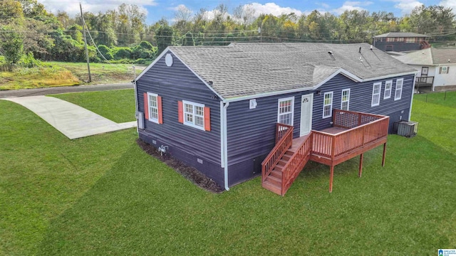 rear view of house featuring a lawn and a deck