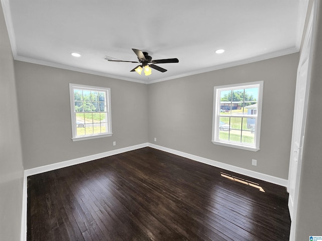 spare room with a healthy amount of sunlight, ornamental molding, dark wood-type flooring, and ceiling fan