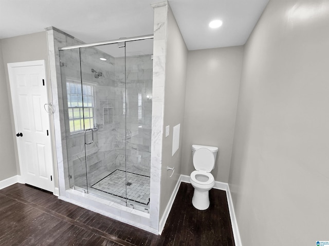 bathroom with an enclosed shower and toilet