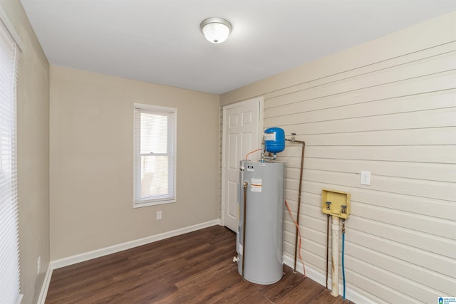 washroom featuring dark hardwood / wood-style flooring, hookup for a washing machine, and electric water heater